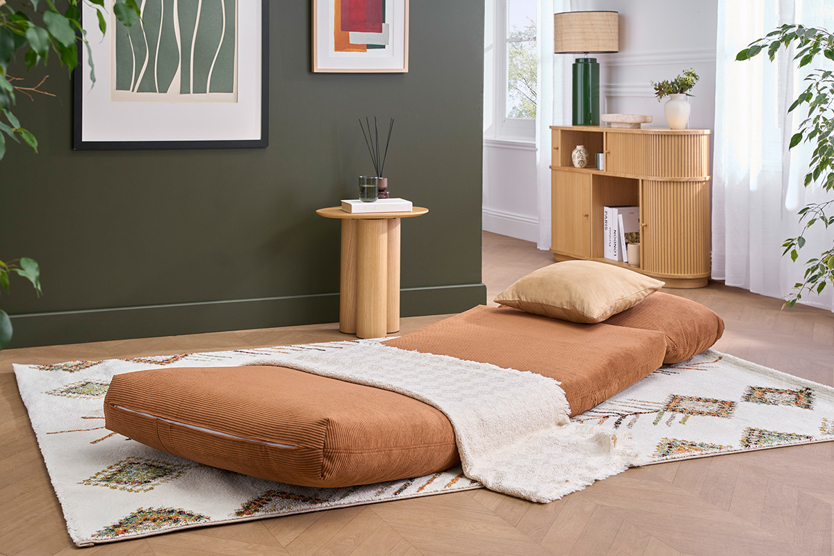 Sessel SPENCER in gebranntem Cordstoff, ausgeklappt in einem Wohnzimmer mit Dekoration.