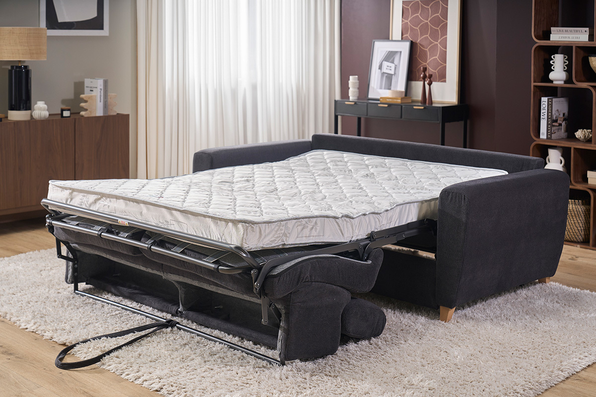 Anthrazitgraues Schlafsofa mit ausgeklappter Matratze, Seitenansicht, verstellbare Kopfst�tzen.