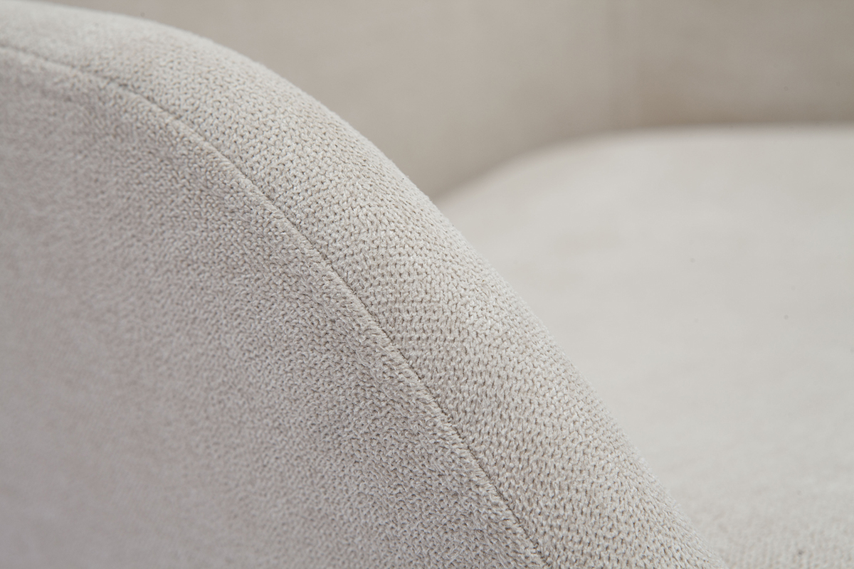 Nahaufnahme eines beige Samtstoff-Effekts eines skandinavischen Sessels.