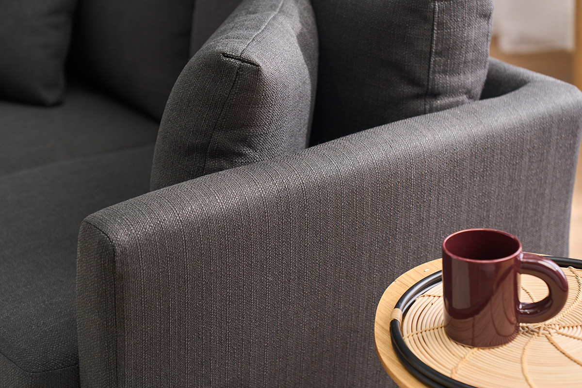 Dunkelgraues 2-Sitzer-Sofa OSLO in Gro�aufnahme mit einer Tasse auf einem hellen Holztisch.